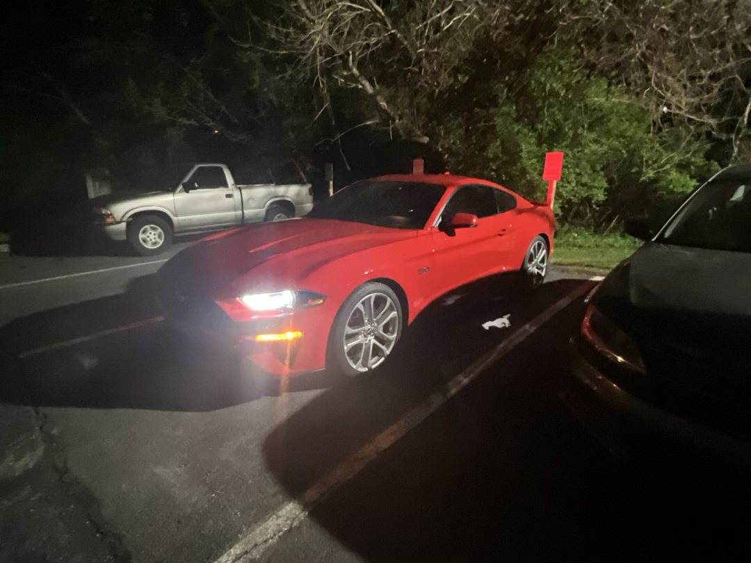 Mustang GT at night with headlights on